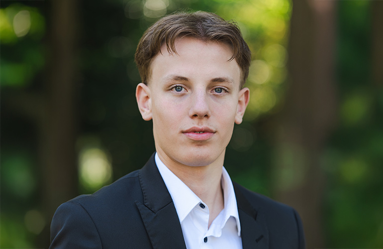 Portrait von Filip Nikolov vor Parklandschaft